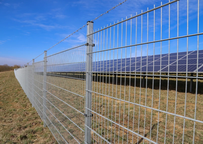 Solar panels behind metal fence